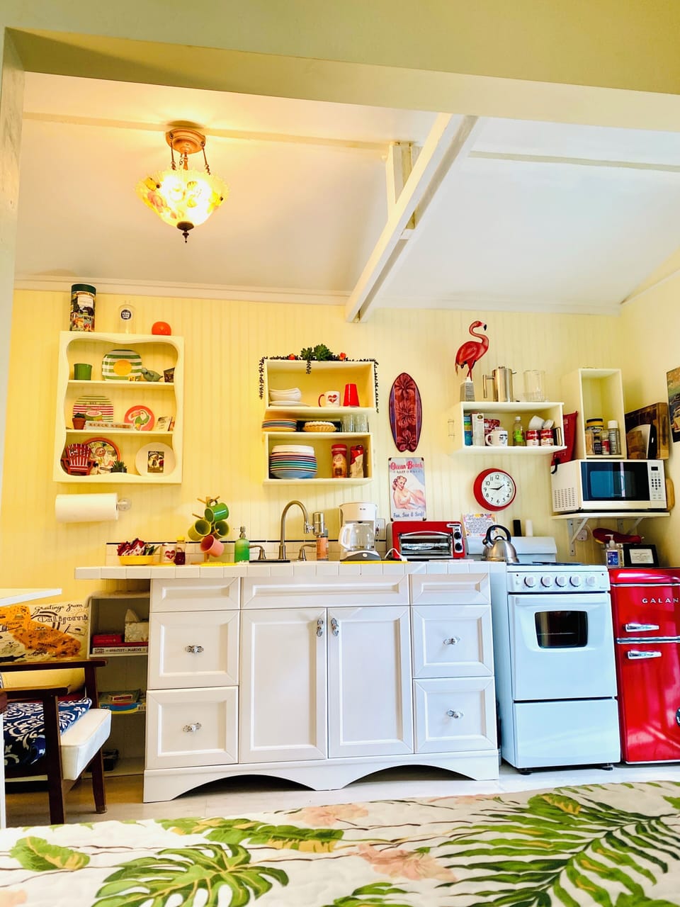 cute little kitchen, coffee maker with coffee and supplies. 
