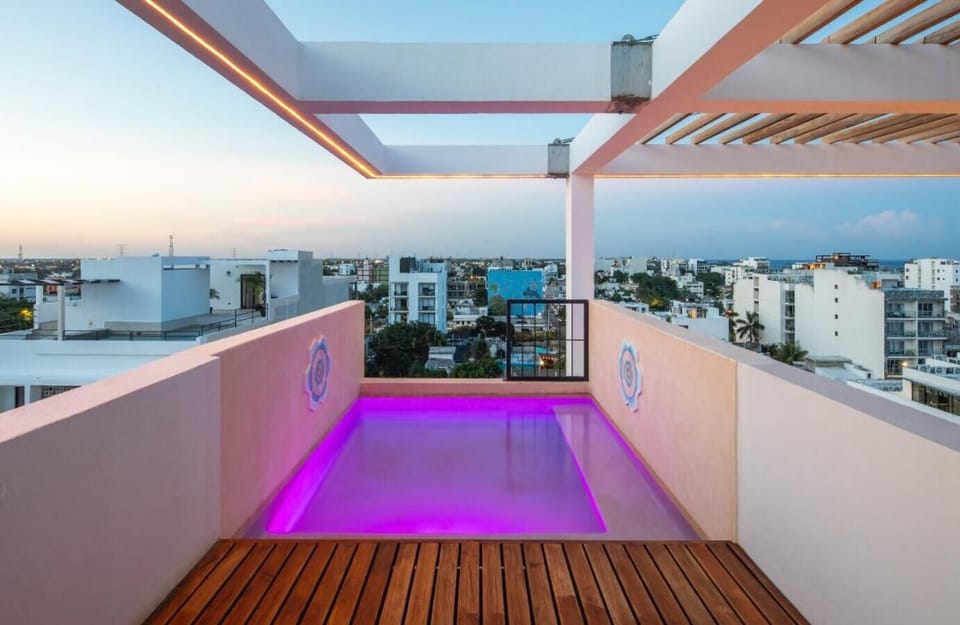Experience the magic of the rooftop infinity pool as the sun sets over the city.