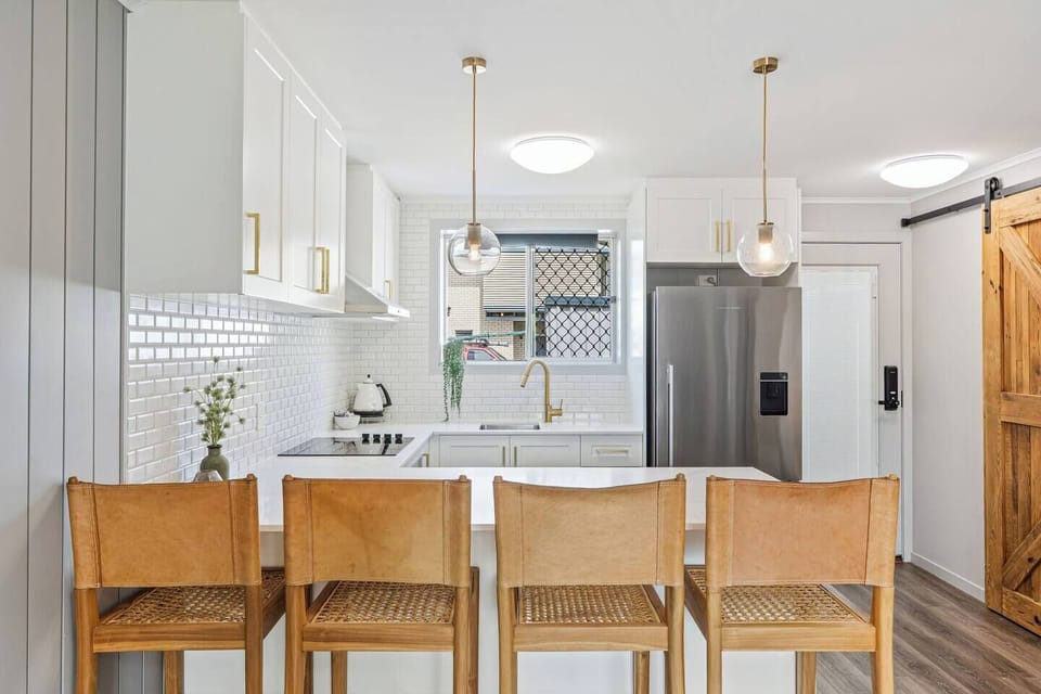 While there’s no formal dining table, the breakfast bar with seating for four is ideal for a quick bite or morning coffee before heading out.