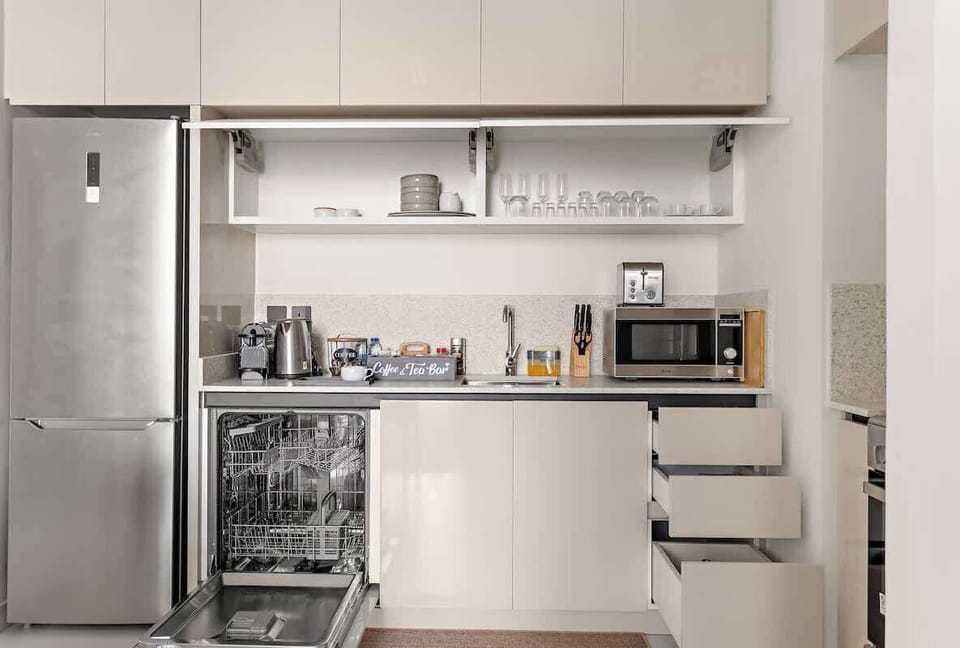The  kitchen comes fully equipped with all essentials, from cooking utensils, crockery, and cutlery to modern appliances. It includes an electric stove, oven, microwave, kettle, refrigerator, dishwasher, and toaster. 