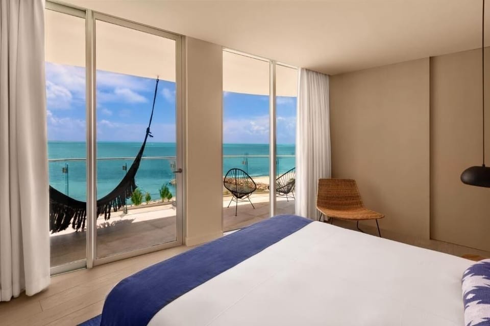 Wake up to turquoise ocean views from your plush bed.