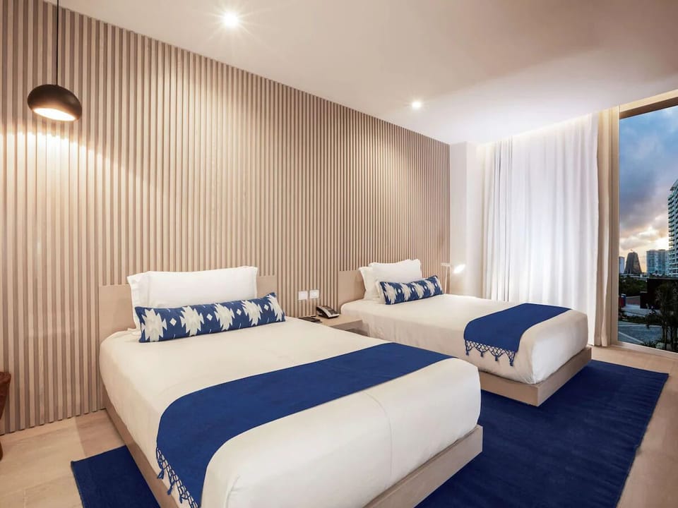 Drift off on crisp linens in a calm, modern room.