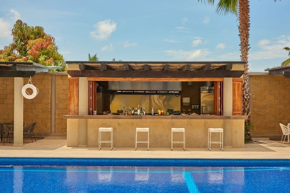 Grab a chilled drink at the stylish poolside bar.