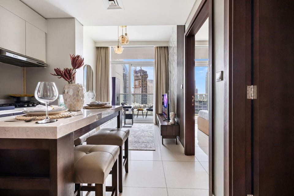 Dining area with open living space and balcony access.