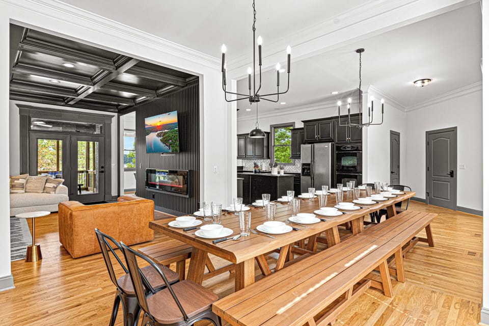 Spacious dining area with a long wooden table, perfect for large gatherings.