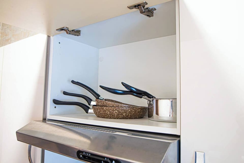 Fully stocked kitchen with pots and utensils for all your cooking needs.