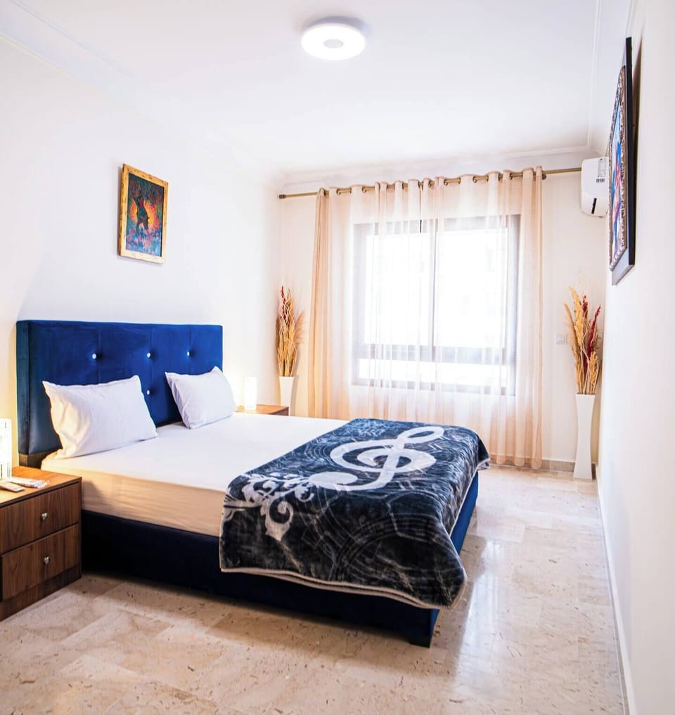 Bright corner of the master bedroom with natural sunlight streaming through the window