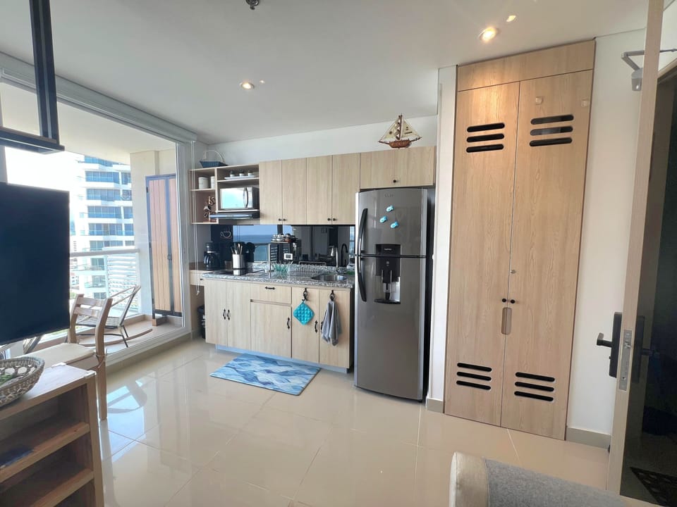 Fully equipped modern kitchen, featuring sleek cabinetry and high-end appliances