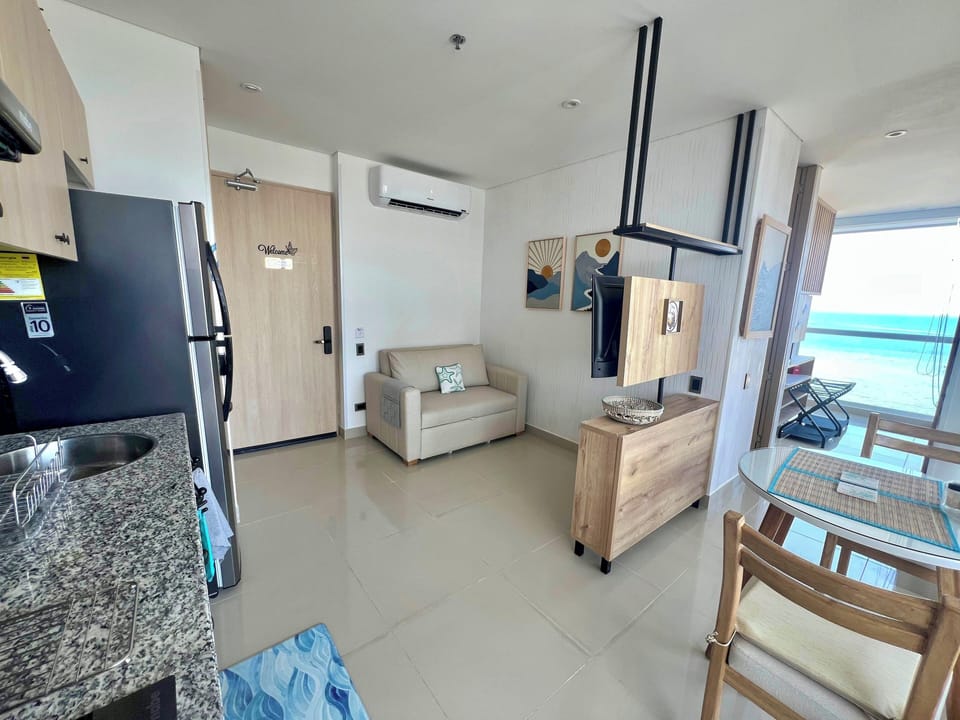 Living room featuring sofa bed (for 1 person, sleek furnishings, AC and TV stand