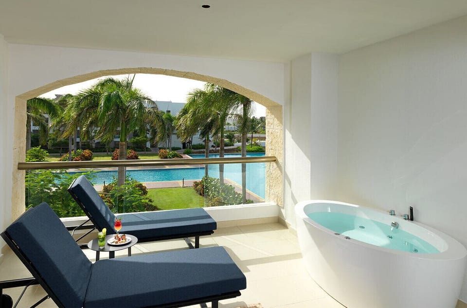 Soak in your private hot tub while overlooking lush palms.