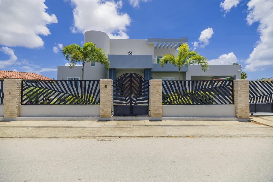 Arrive in style — this modern villa features a private gated entrance and sleek design.