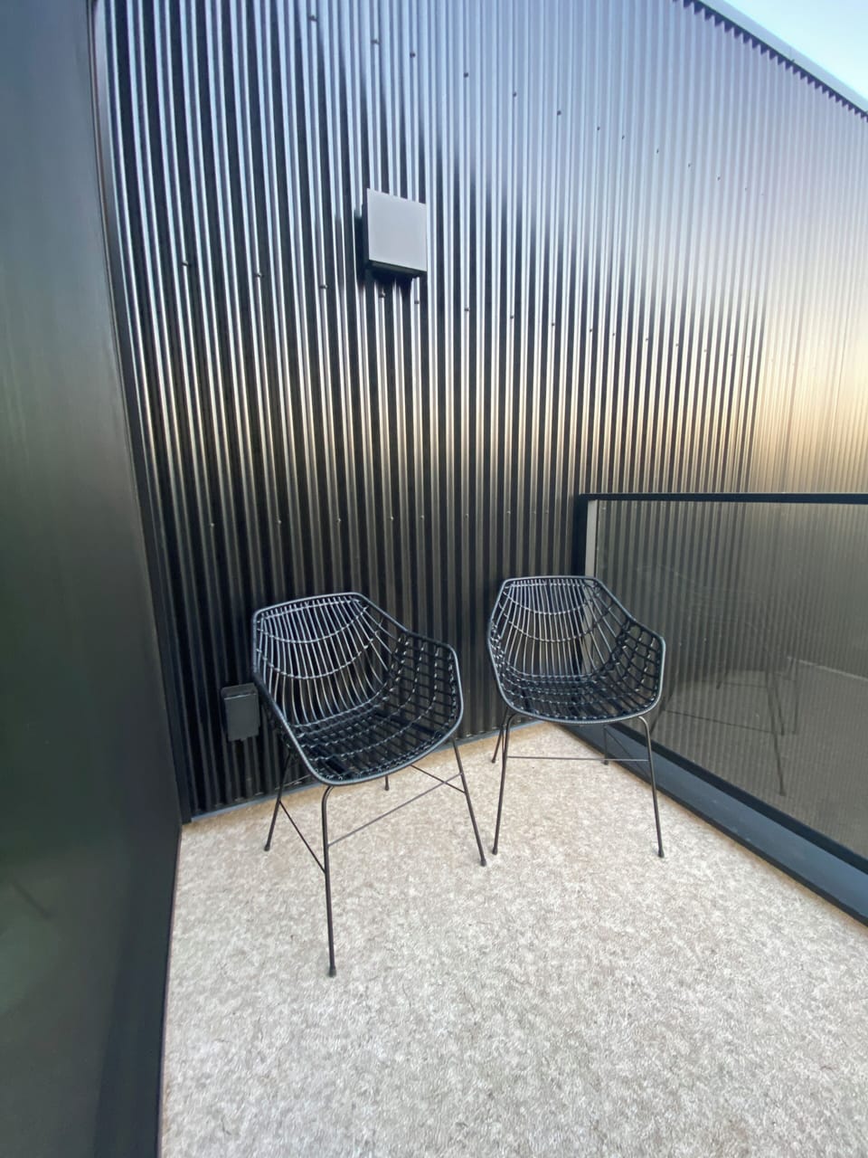 Balcony with glass railing and mountain views in winter