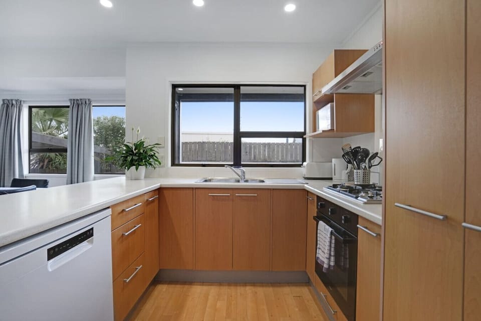 The kitchen has an oven, cooktop, dishwasher, microwave and fridge/freezer.
