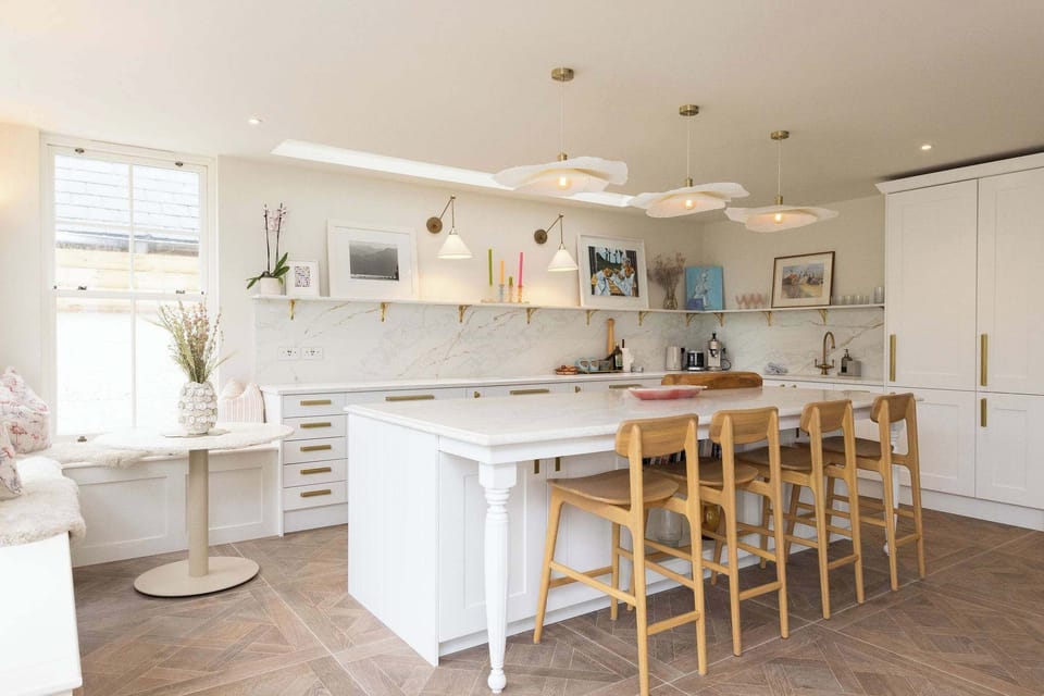 Gather around the sun-drenched island in this stunning, open-plan kitchen.