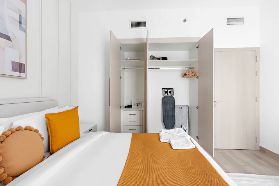 Simple bedroom w/ a warm headboard & neat layout