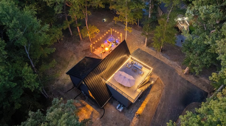 Evenings glow with rooftop lights, cozy fires, and cabin charm.