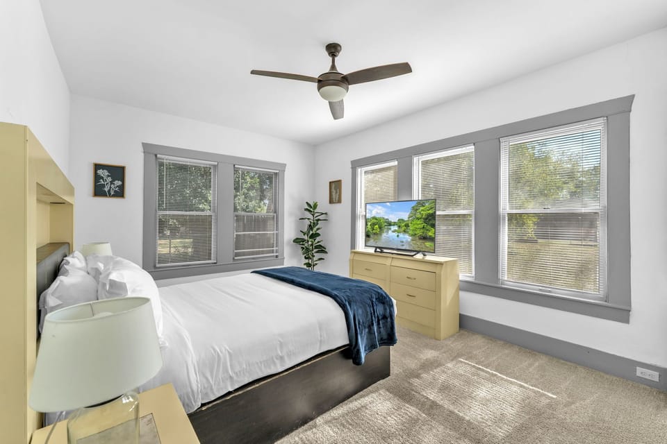 Cozy sunlit bedroom offering a peaceful spot to unwind and rest.
