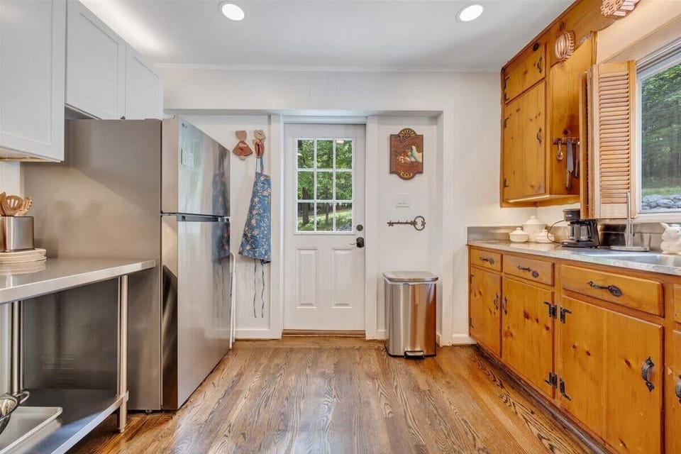 Kitchen with wooden cabinets and side entrance