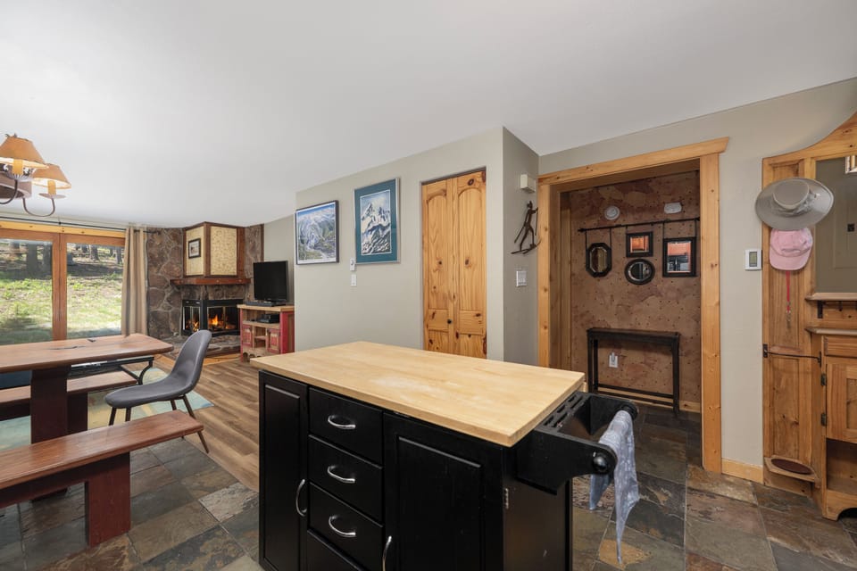 Your mountain retreat's heart combines rustic charm with modern comfort—gather around the kitchen island or cozy up by the fireplace.