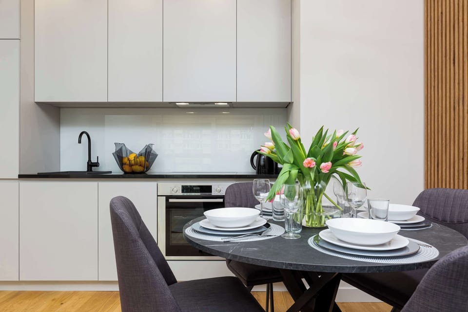 The sleek design of the kitchenette blending seamlessly with the living area.