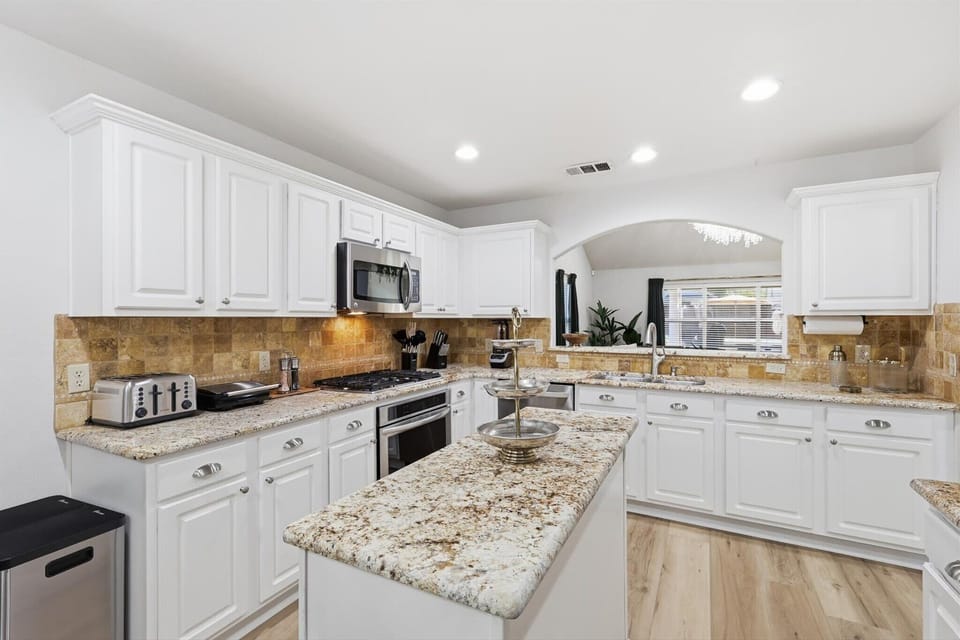 Spacious and functional with a center kitchen island, this fully equipped kitchen has everything you need for all your cooking needs and more!