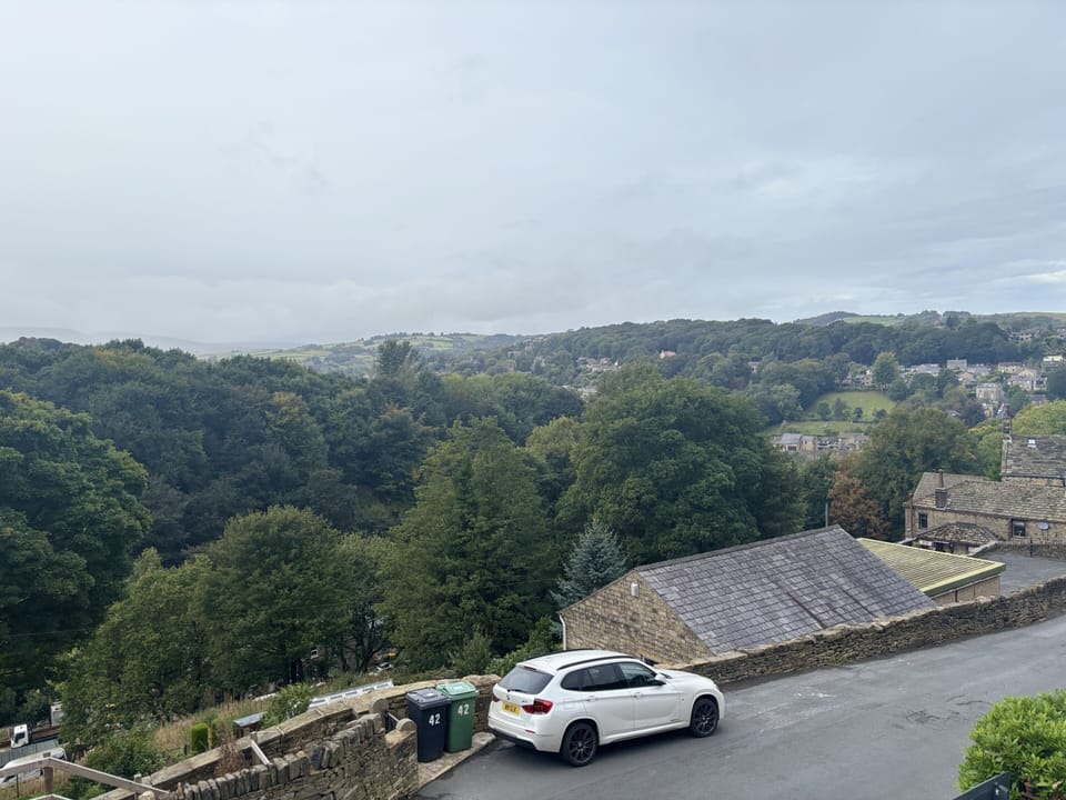 Please park where the white car is parked.