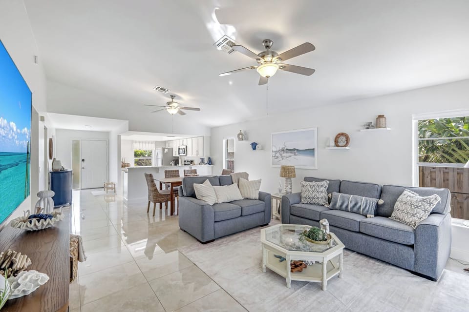 Living room with 75 inch Tv that you can see from the outdoor space. 