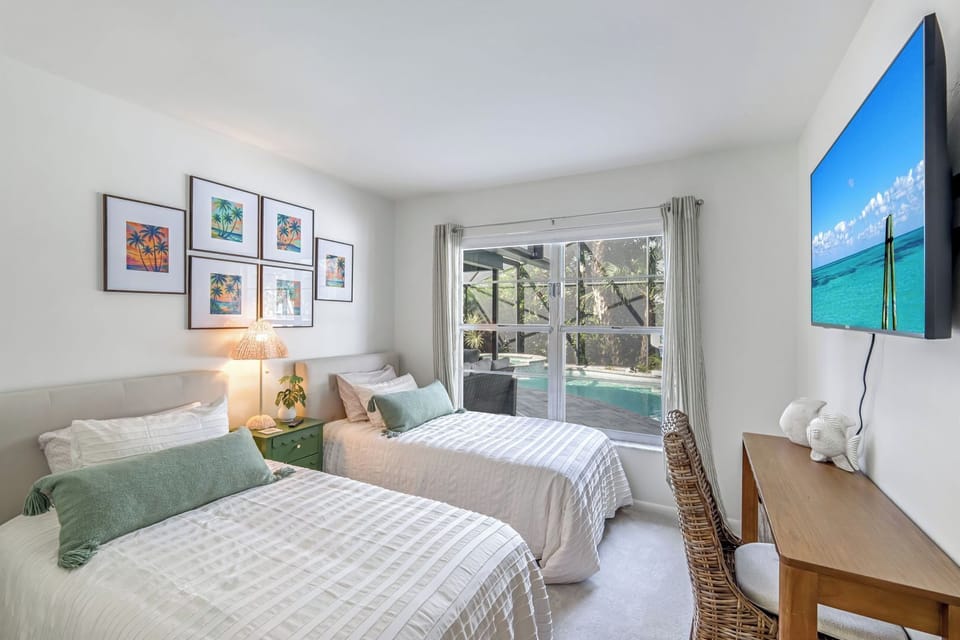 Third bedroom with two twin beds,  desk for work space & 50 inch smart TV