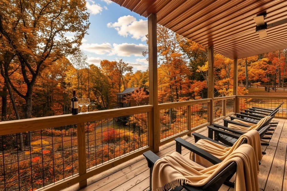 Relax on the covered deck with forest views showcasing vibrant autumn colors.