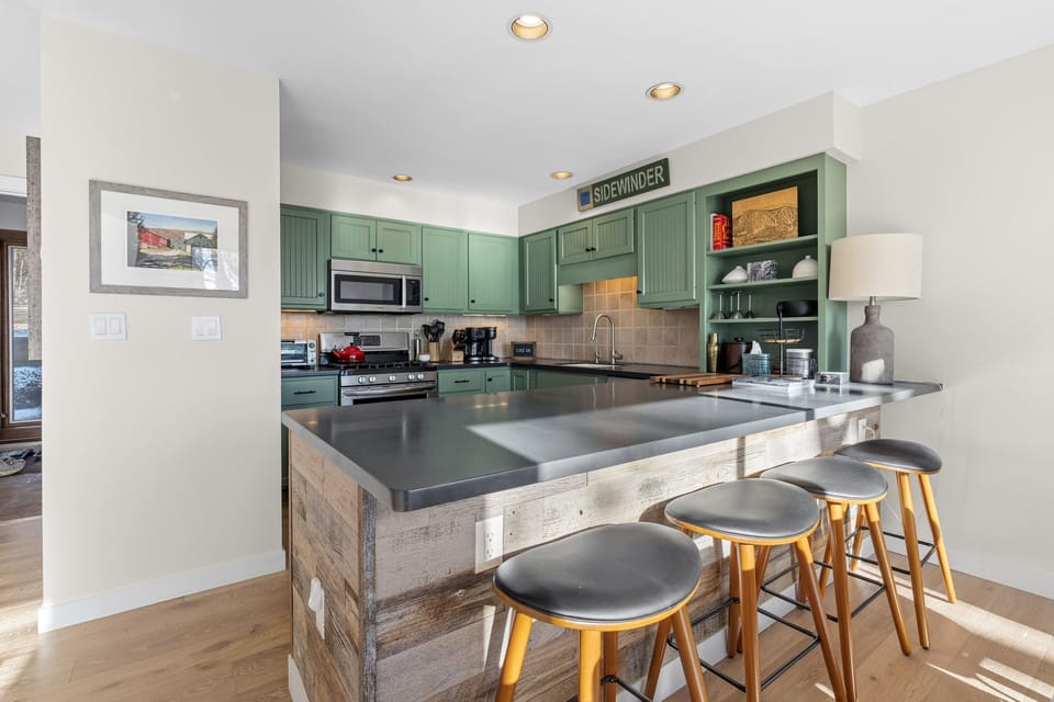 Updated and fully-outfitted kitchen with stainless appliances, 4 barstools. 