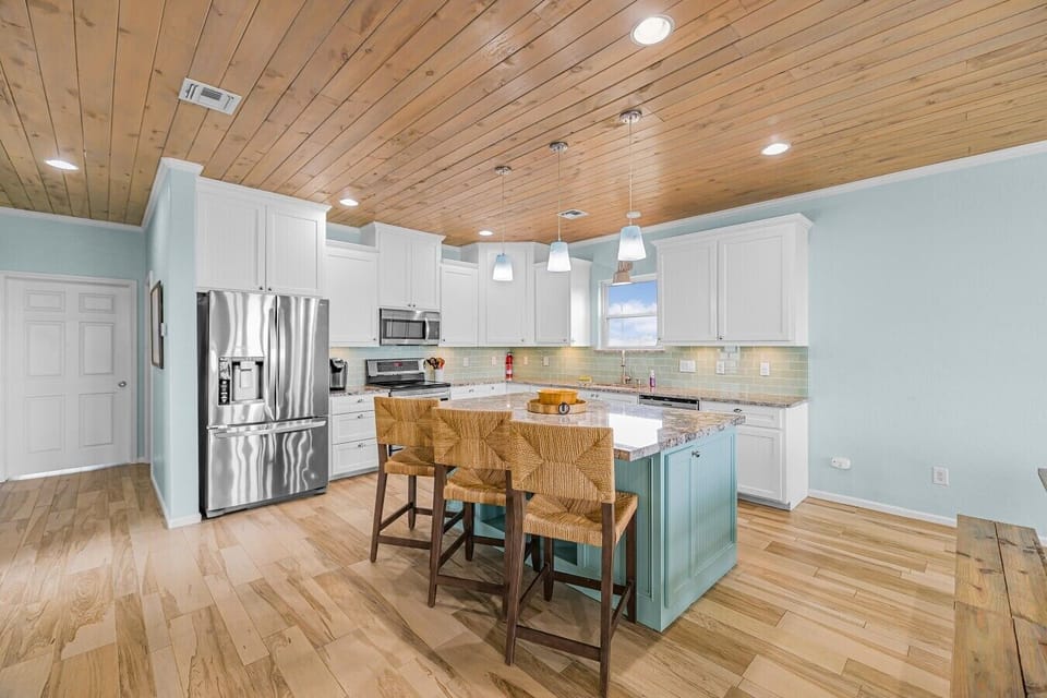 A spacious, fully equipped kitchen and oversized island make feeding the whole crew easy.