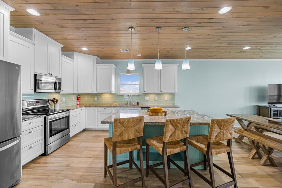 Gather around the large kitchen island after a day on the water—plenty of prep space and seating for the group.