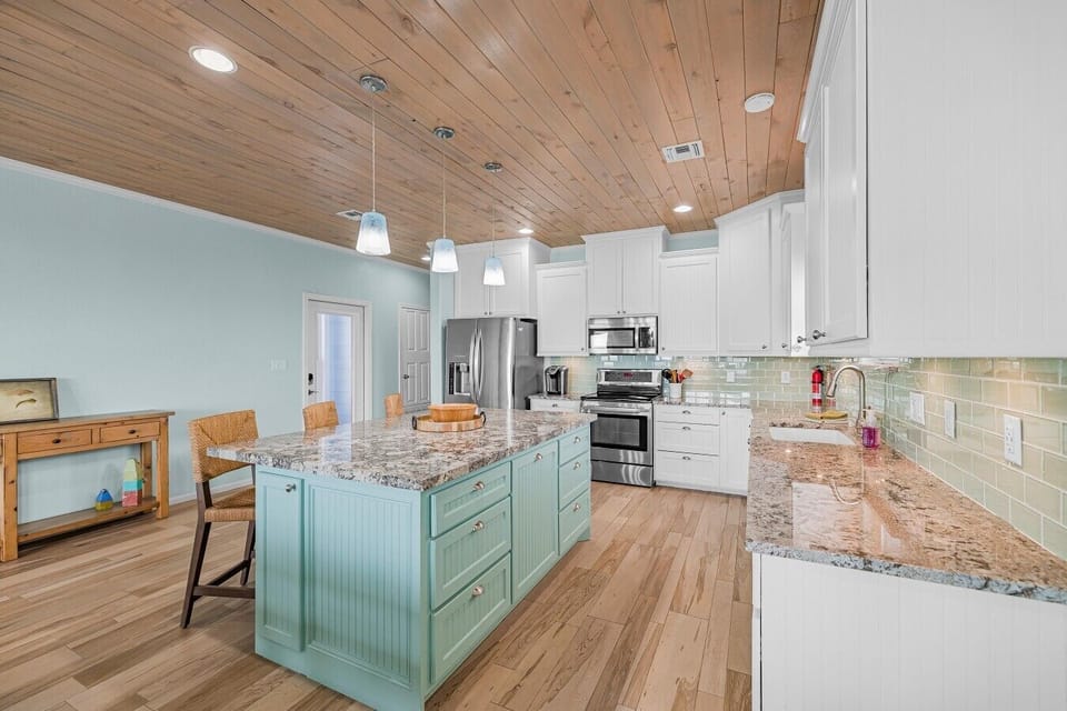 A spacious, fully equipped kitchen and oversized island make feeding the whole crew easy.