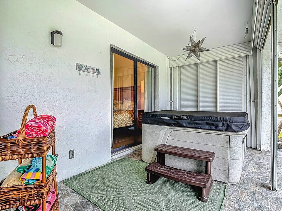 Cozy enclosed patio with hot tub and easy bedroom access.