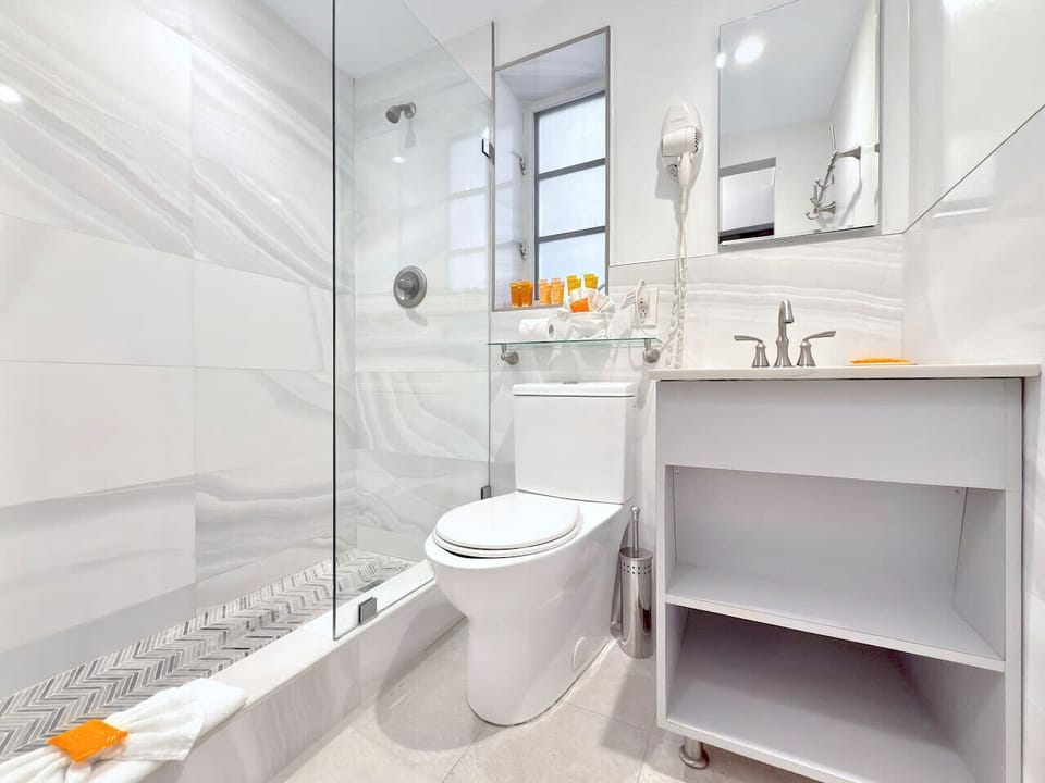 Fresh, clean full bathroom with shower and all the essentials.