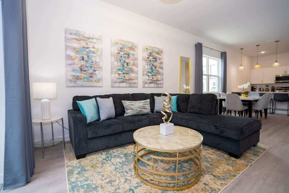 Bright and spacious living room with cozy seating and Smart TV entertainment.