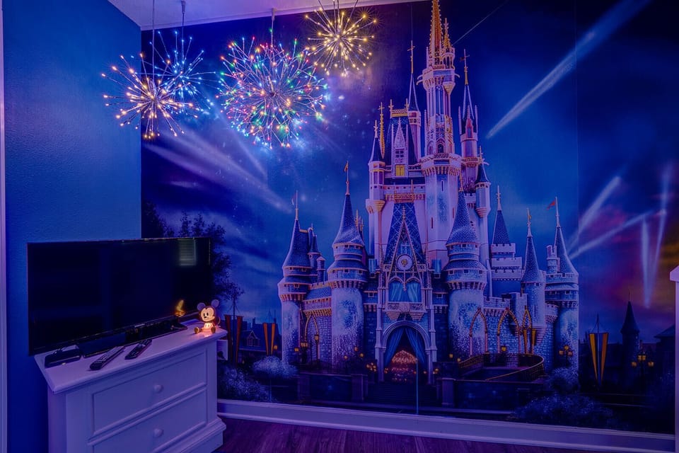 Enchanting Disney-themed bedroom with Cinderella's Castle mural & fireworks.