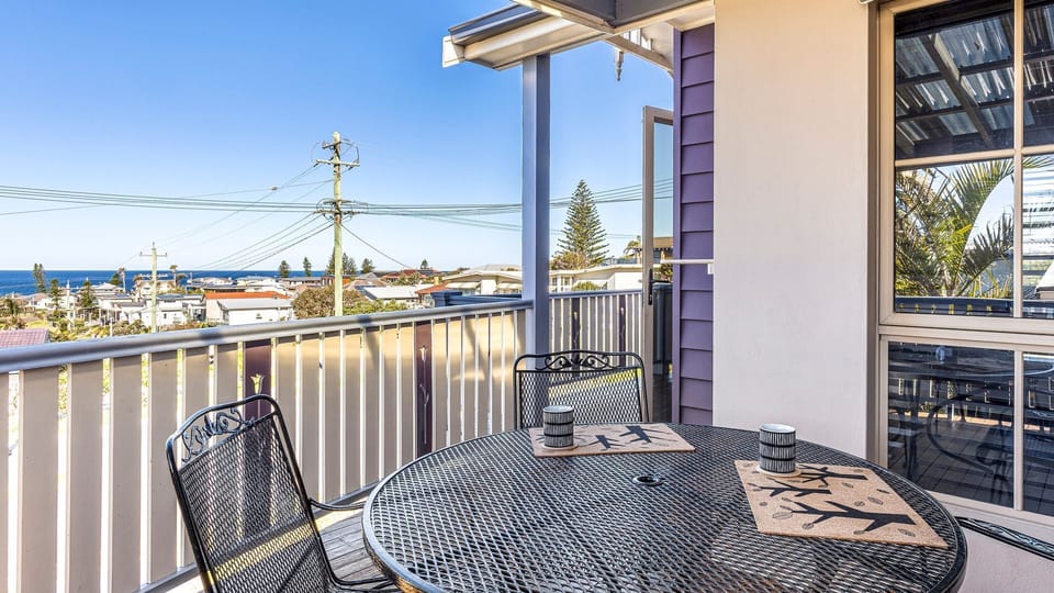 Veranda with table, perfect for morning coffee with ocean views.