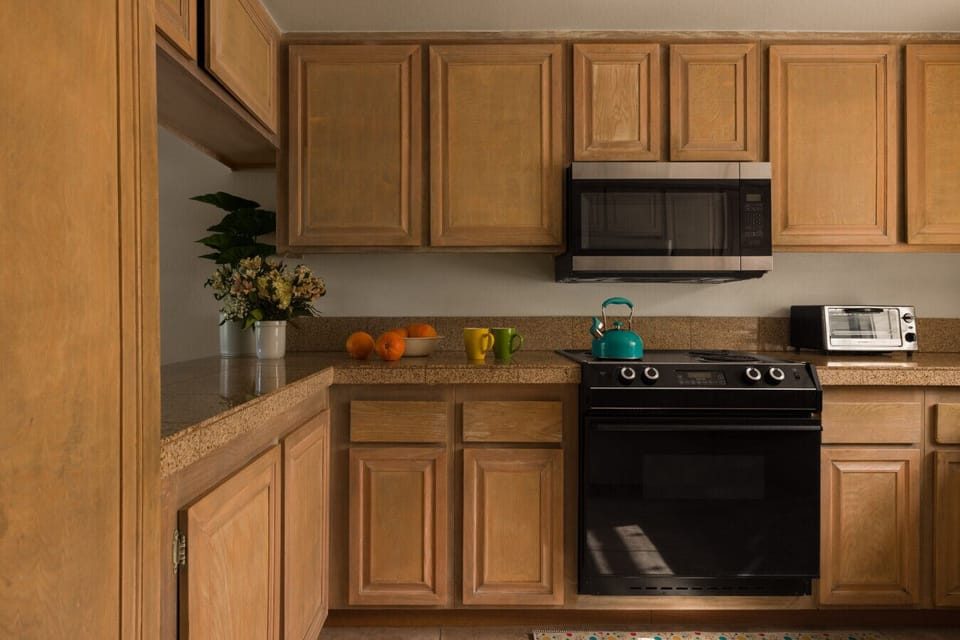 Earth-toned kitchen designed for comfort and convenience — cook, dine, and feel right at home.