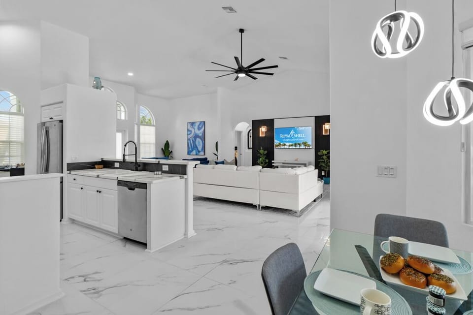 Bright, open-concept kitchen, dining, and living area with modern finishes, plenty of natural light, and seamless flow—perfect for cooking, dining, and relaxing together.
