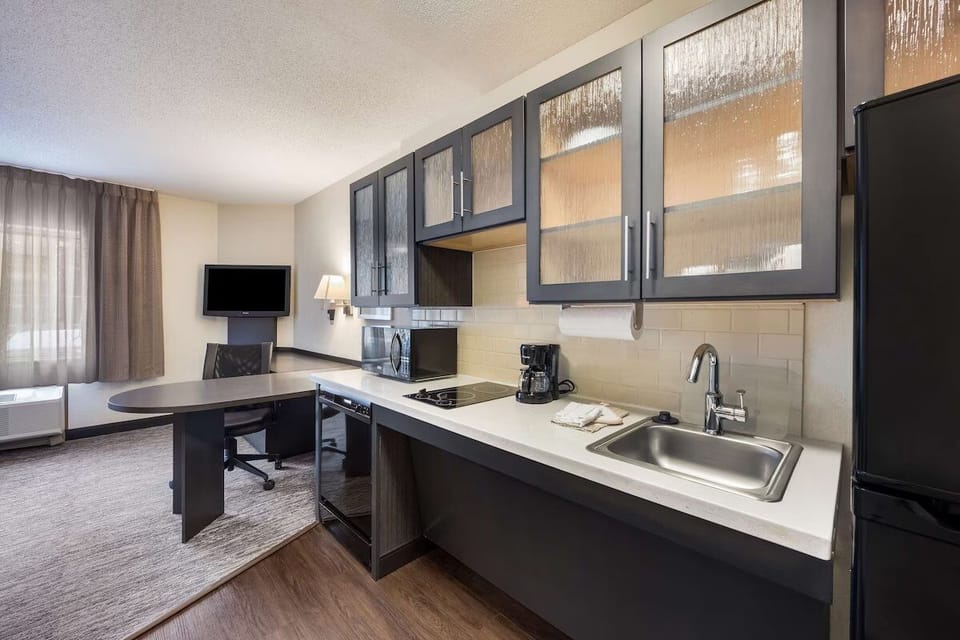 Cook easy meals with a sleek kitchenette and modern finishes.