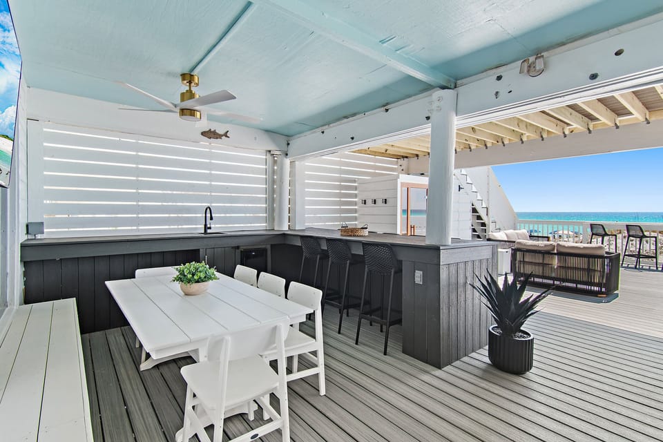 Incredible covered bar & dining area at Green Reef 1 - Plenty of seating to hang and dine, LED lighting, sink, mini-fridge, gas grill + a big Smart TV so you can watch the waves AND the game!
