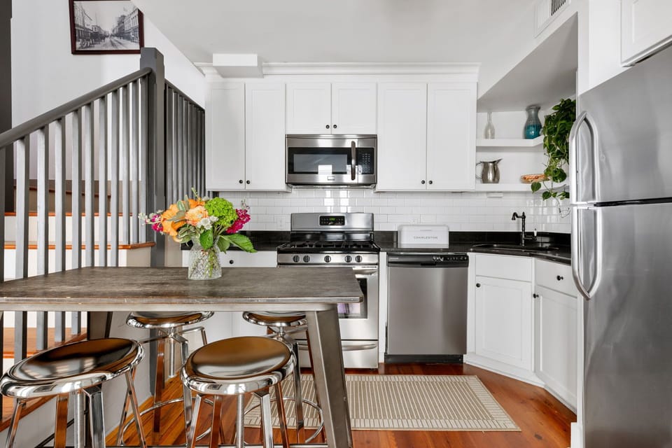 Fully equipped kitchen with modern appliances and a cozy dining area with seating for 4.