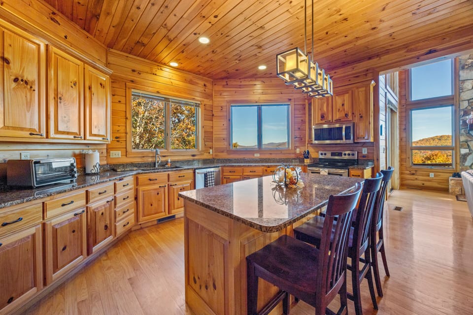 Fully stocked chef's kitchen with big windows and stunning mountain views. 