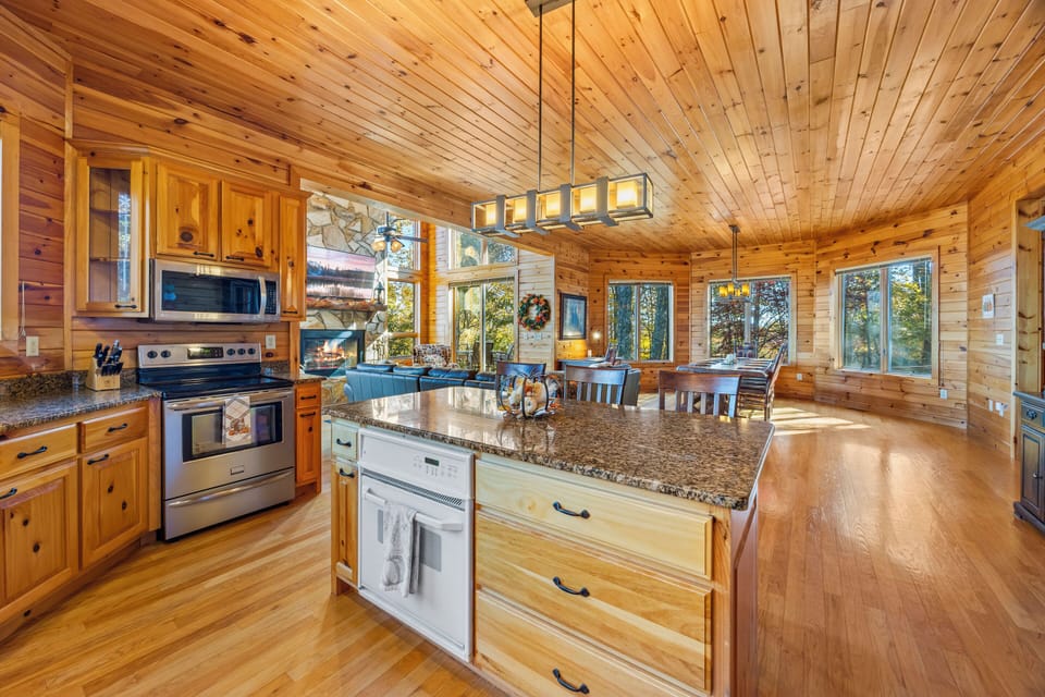 Dream kitchen with double ovens, spacious counters, and a large granite island. 