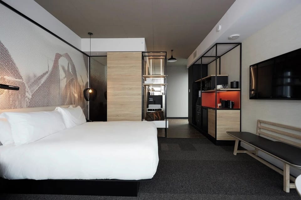 Kick back with easy TV viewing in a calm, modern suite.