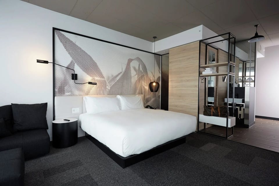 Stretch out on crisp linens beneath warm designer lighting.