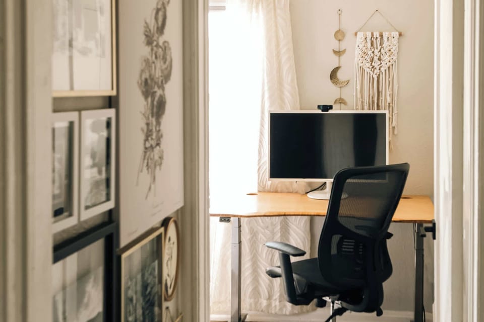 Bedroom 2 has a stand/sit desk, chair, and monitor