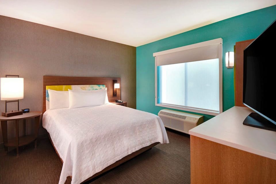 Unwind in a serene bedroom with soft lighting and calm tones.