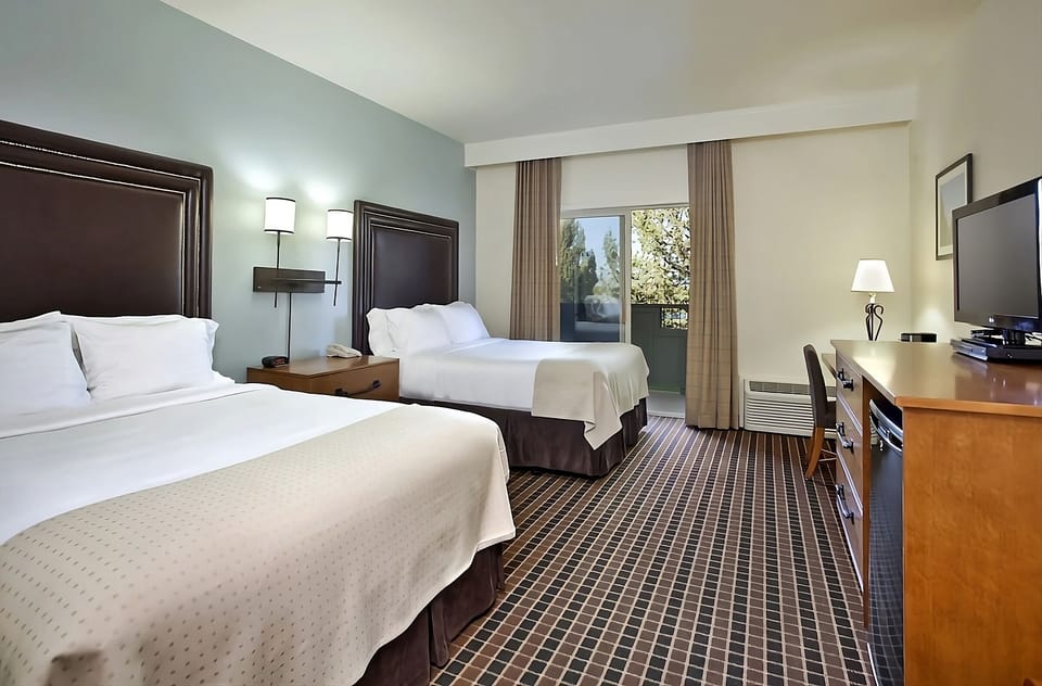 Stretch out in a spacious double-queen room with warm lighting